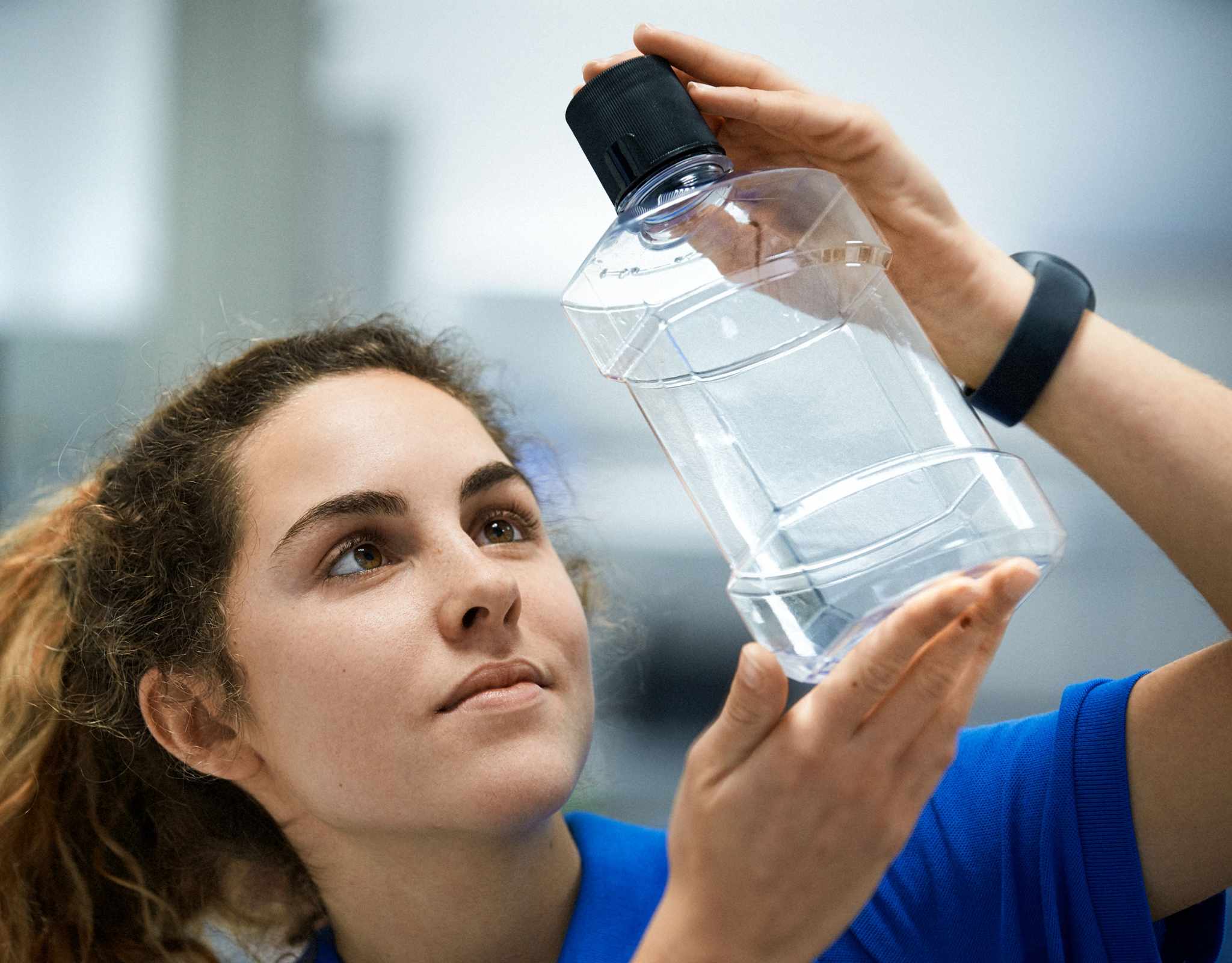 employee holds full service created bottle 