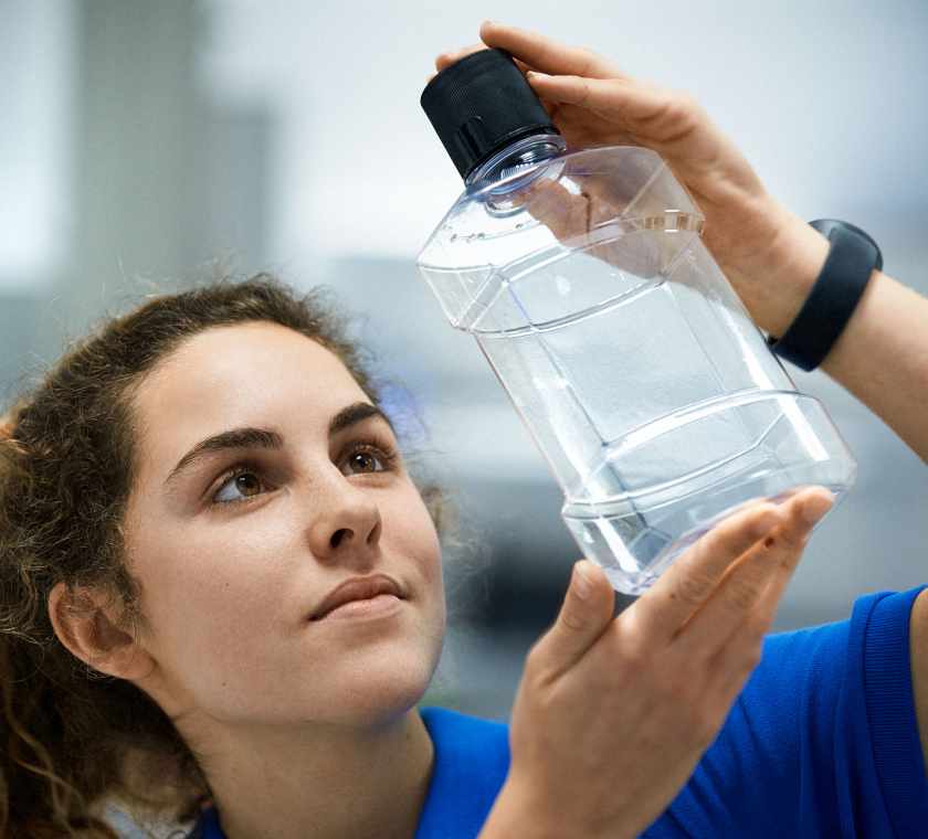 employee holds full service created bottle